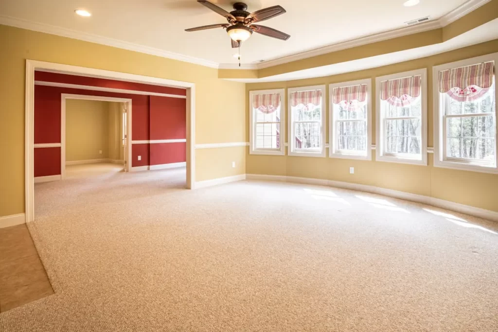 Empty room with wall to wall carpet.