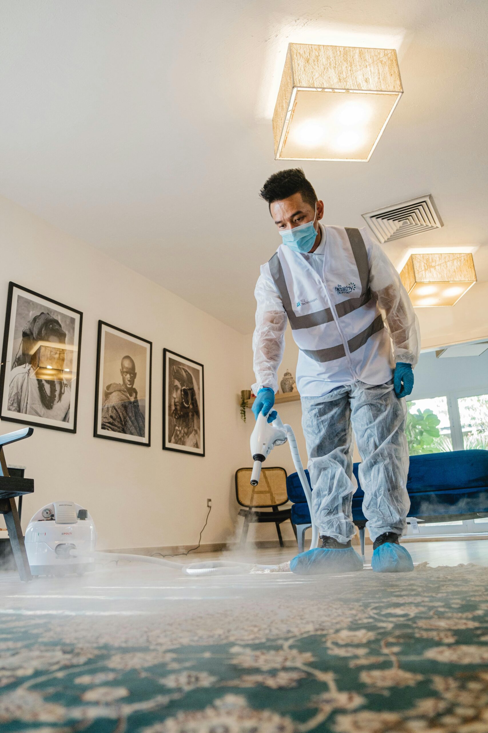 A professional cleaner from Cure Carpet performing thorough carpet cleaning in Ajax using advanced equipment for deep cleaning and stain removal.